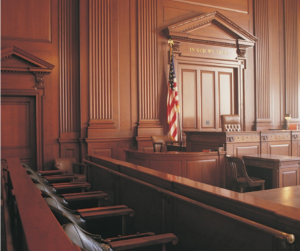 Photo of a courtroom with an American flag in the room.